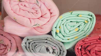 Colorful rolled fabrics displayed in a creative setting