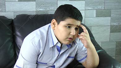 Sad boy. Depressed child at home. Family problems.