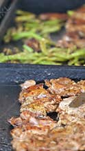 Grilling marinated meat and vegetables on an outdoor grill