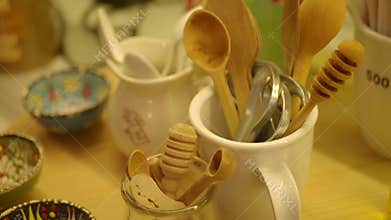 Wooden utensils in kitchen container on a table