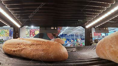 POV video of a man picking fresh bread with tongs from a bakery shelf in a supermarket. View from inside the shelf, showing
