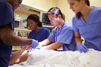 Medical Team Working On Patient In Emergency Room