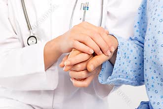 Medical doctor holing senior patient's hand