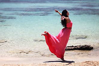 Beautiful girl dancing on the beach