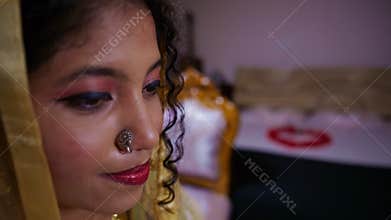 Newlywed Muslim lady gazes at herself at mirror