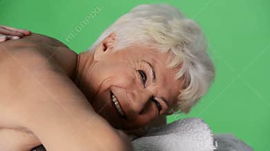 An old lady lying at spa salon.