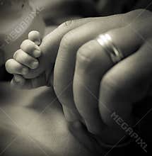 Baby grabbing dad's finger