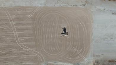 Drone video a tractor is spreading cassava on a cassava drying field