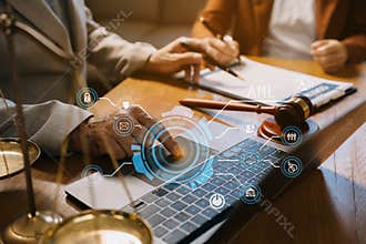 Judge in a courtroom using laptop and tablet with AML anti money laundering icon on virtual screen
