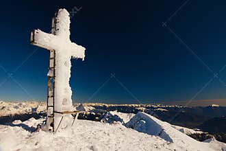 Frozen cross on the top of mount Pizzo Arera, Orobie Alps, Italy.