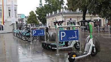 parking for bikes and electric scooters in the city on a roadside