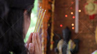 Asian girl praying in temple, wat, pagoda, Phnom Penh, Cambodia
