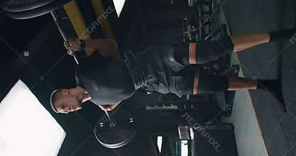 Young Man Performing Heavy Squats at Modern Gym, Fitness Focus