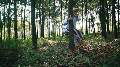 Crouching in a lush forest