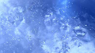 Closeups of bubbles forming and rising highlighting the dynamic transformation of water as it heats