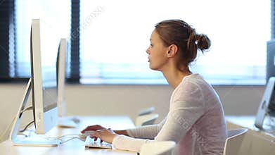 Young female student in a computer classroom