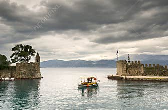Nafpaktia 2014 (102) The Port and the fortifications with a fishing boat
