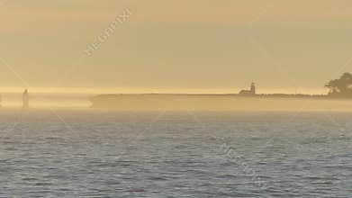 Lighthouse in the Haze with Sailboat