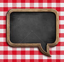 Menu chalkboard speech bubble on picnic tablecloth