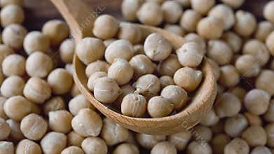 raw chickpeas in a wooden spoon close-up. macro