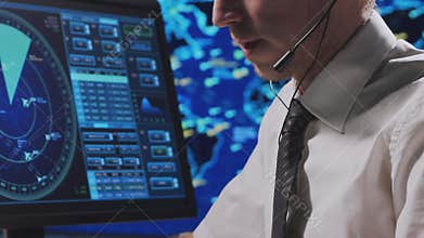 Professional air traffic controller in the control tower. Aircraft control officer works using radar, computer navigation and