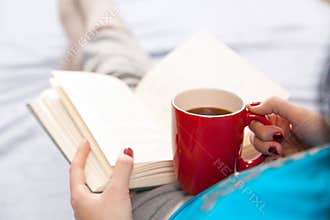 Woman reading a book in bed