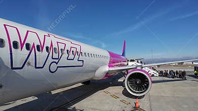 Passengers getting on the Wizz Air Airbus A321 Neo plane on a sunny day in Sofia, Bulgaria