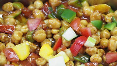 Colorful salad features fresh vegetables and chickpeas in vibrant mix