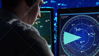 Professional air traffic controller in the control tower. Aircraft control officer works using radar, computer navigation and