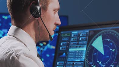 Professional air traffic controller in the control tower. Aircraft control officer works using radar, computer navigation and