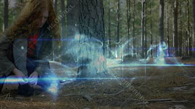 female designer crouching in pine forest clearing, interacting with blue energy lines for tech