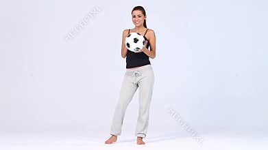 Beautiful woman with soccer ball on white