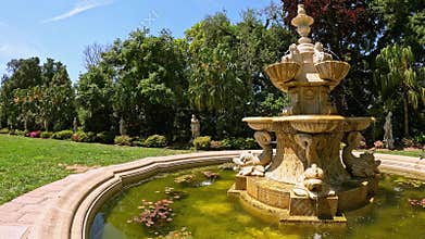 footage of a water fountain with lush green trees and flowers at Huntington Library and Botanical Gardens in San Marino California