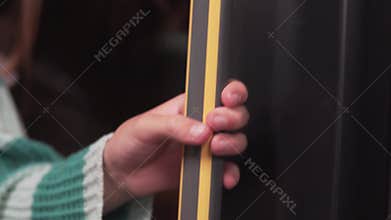 A person is currently holding a piece of paper firmly in their hand