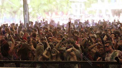 People dancing in slow motion at colour festival