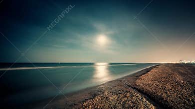 Timelapse. Night seascape landscape with full moon on sand beach. Rimini. 4K