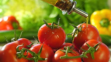 Pouring olive oil over tomatoes