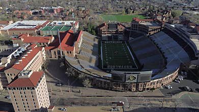 Tuscan Vernacular Revival buildings surround home of Buffaloes football at University of Colorado. Academic halls feature