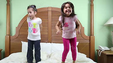 Girls jumping in the bed