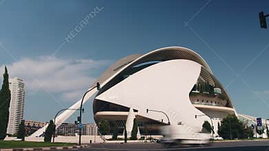 Urban traffic flowing past the futuristic palau de les arts reina sofia in valencia