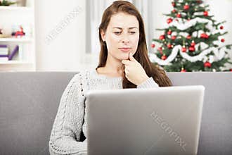 Young girl surfing with laptop at christmas