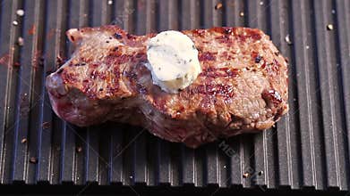 Grilling steak with a piece of butter