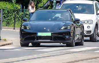 Poland Krakow May 24, 2026 1:44 PM. Porsche Taycan - electric luxury car on the street.