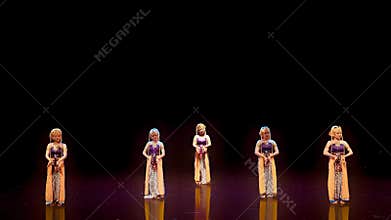 Symmetrical Formation of Traditional Female Dancers on Dark Stage