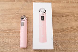 Bar, Montenegro: February 6, 2026: Pink medicube booster pro skincare device beside white box on wooden table, trendy