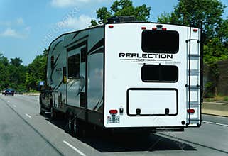 Pennsylvania, U.S.A - Jul 2, 2026 - Reflection 150 Series fifth-wheel trailer towed by a pickup truck on the highway, equipped
