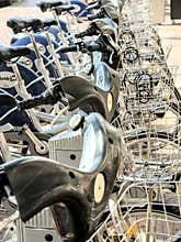 Bicycles for rent with basket parked in a row in the city of Valencia, Spain