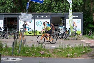 Road Cyclist Passing Bicycle Rental Station In Kyiv