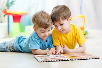 Kids brothers read a book at home