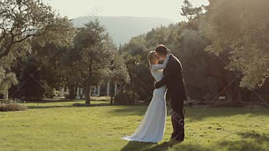 Fashionable young wedding couple kiss each other
